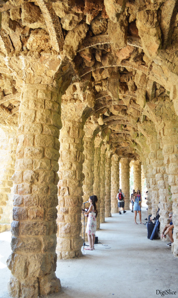 Artist in colonnaded footpath, Park Guell - Spain 